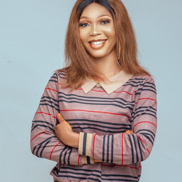 Avery Liang, Lead Design Curator at Paper Field View, reviewing corporate floral arrangements